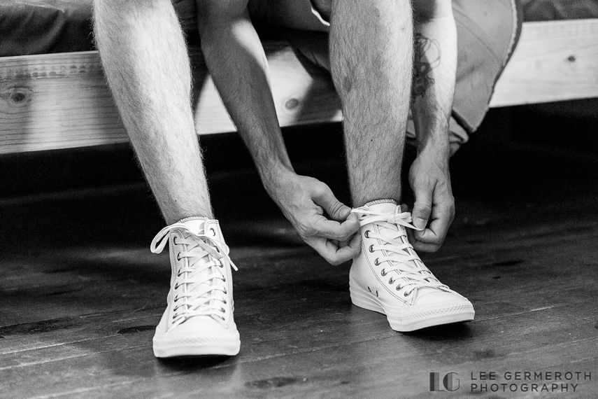 Groom tying shoes -- Camp Takodah Wedding in Richmond NH by Lee Germeroth Photography