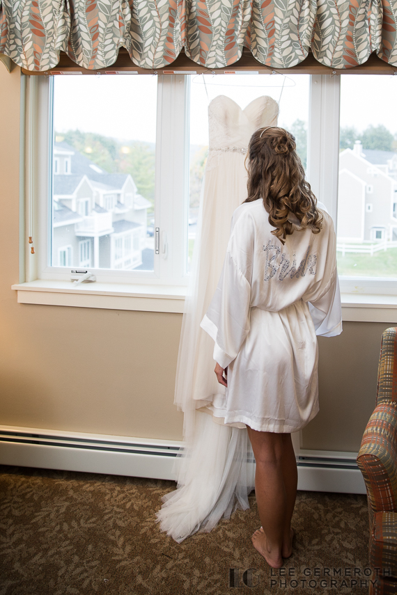 Bride looking at dress -- Mount Ascutney Resort Wedding by Lee Germeroth Photography