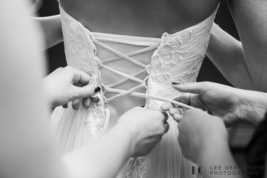 Bride getting into dress -- Mount Ascutney Resort Wedding by Lee Germeroth Photography