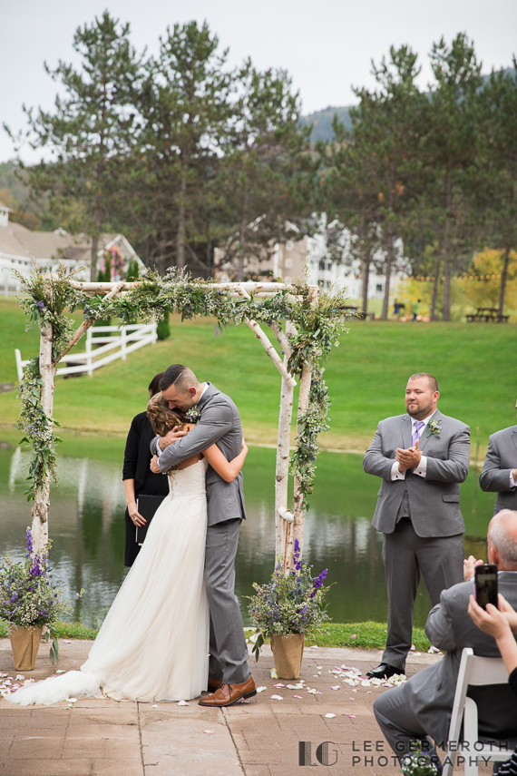 Bride and Groom hug after ceremony -- Mount Ascutney Resort Wedding by Lee Germeroth Photography